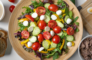 Vegetable salad with mozzarella and lettuce. Other ingredients are visible.