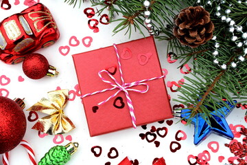 A gift box lies on a white background on a Christmas background.