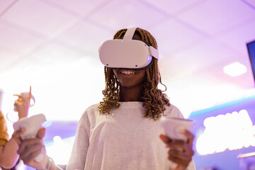young african american woman with braids playing with virtual reality glasses