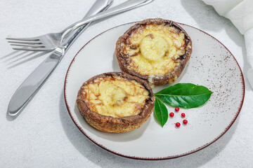 Baked portobello mushrooms with cheese and spices. Healthy vegan food ready to eat