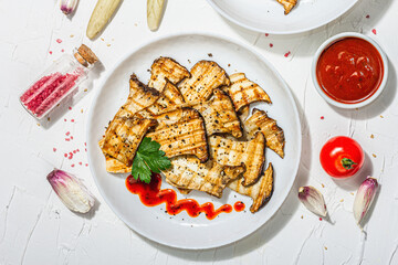 Fried slices Pleurotus eryngii mushrooms with sauce, spices and herbs. Healthy vegan food concept