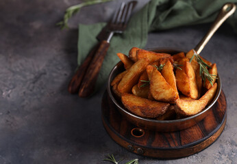 potato wedges with rosemary fried in a pan