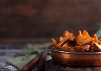 potato wedges with rosemary fried in a pan
