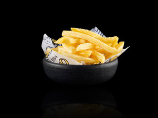 French fries bowl isolated on black background. Studio shoot.