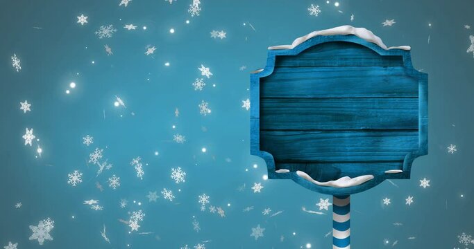 Animation of christmas sign with copy space with glowing spots on blue background