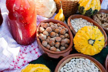  Colorful display of fresh, seasonal produce, including pumpkins, nuts, and seeds, ready for the harvest season.