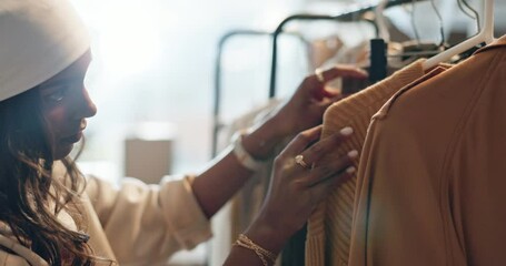 Sale, shopping and Indian woman with clothes, search or outfit choice at boutique or thrift store. Fashion, decision and female customer looking for discount, deal or checking fabric quality at mall - Powered by Adobe