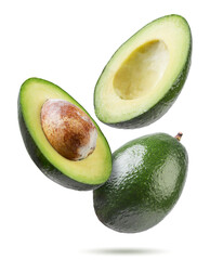 Ripe avocado and two halves flyon a white background. Isolated