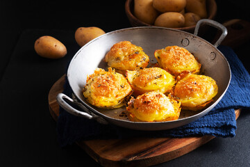 Food concept Homemade Gratin potatoes stack on black background with copy space