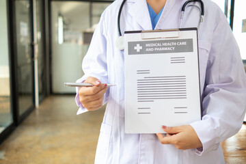 female doctor is reviewing documents to review and diagnose illness and female doctor has...
