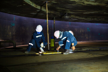Male worker inspection vacuum test bottom plate tank petrochemical steel weld leak