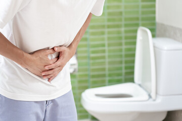 Constipation and diarrhea in bathroom. Hurt man touch belly  stomach ache painful. colon inflammation problem, toxic food, abdominal pain, abdomen, constipated in toilet, stomachache, Hygiene