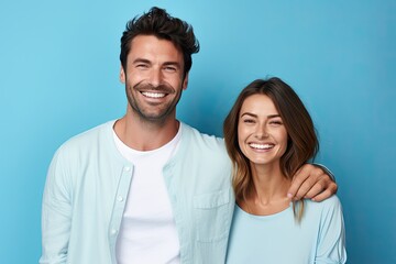 Obraz premium Happy, stylish young couple in a loving and cheerful relationship sharing moments of joy and fun on a blue background.
