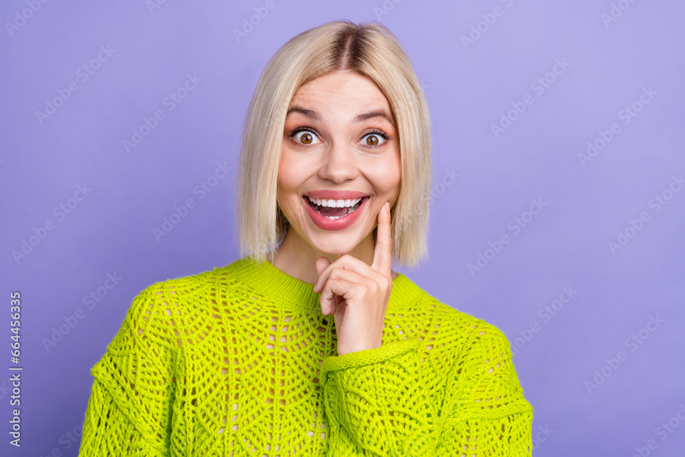 Poster Photo of excited cheerful woman dressed knitted sweater smiling finger cheek isolated violet color background