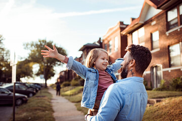 Loving young father holding his father in the street