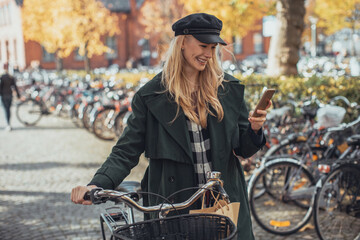 Attractive young woman using a smartphone in the city