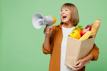 Elderly woman wears brown shirt casual clothes hold shopping paper bag with food products scream in...