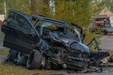 The driver lost control and flew off the road. Serious accident. Black car. The driver was injured. Damage. Close-up, details.