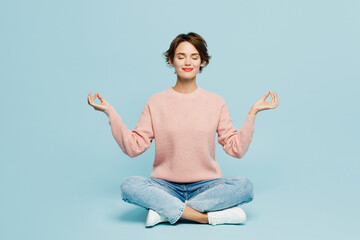 Full body young woman she wear beige knitted sweater casual clothes sit hold spreading hands in...