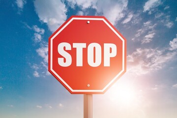 A red alarm stop sign at blue sky background