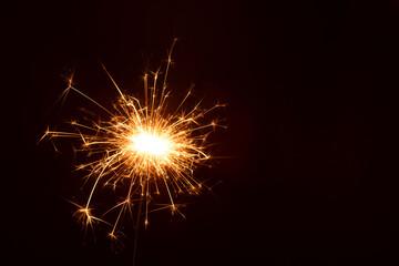 photo in a close-up shot, a golden sparkler of celebration during the New Year, and festivity of...