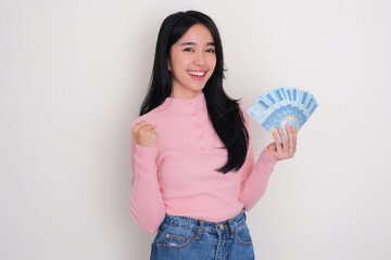 Young Asian woman showing excited expression while holding money
