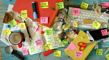Messy workplace,chaotic office, overworked, bureaucracy,red tape concept with grungy desk,sticky...