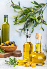 Olive oil in a bottle on texture background. Oil bottle with branches and fruits of olives. Place for text. copy space. cooking oil and salad dressing.