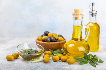 Olive oil in a bottle on texture background. Oil bottle with branches and fruits of olives. Place for text. copy space. cooking oil and salad dressing.