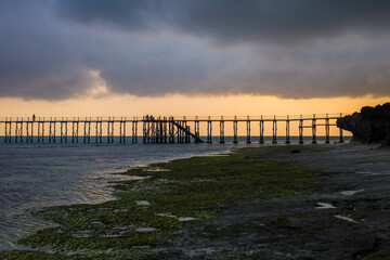 Obraz premium Wooden walkway stretching over the sea at sunrise, Nungwi, Zanzibar, Tanzania