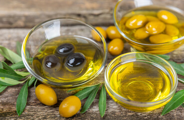 Olive oil in a bottle on texture background. Oil bottle with branches and fruits of olives. Place for text. copy space. cooking oil and salad dressing.