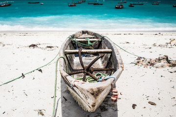 Beautiful Zanzibar coast line. Wooden fisherman boats on sandy beach with blue water background, Zanzibar, Tanzania