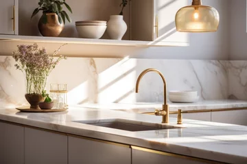 Fotobehang Modern kitchen interior with marble countertops and gold fixtures, soft morning light filtering in. © Jelena