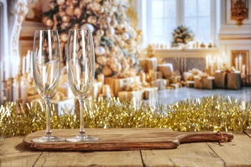Fototapeten Champagne glasses and New Year time party in home interior. Desk of free space.  © magdal3na
