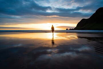 A person walking on the beach at sunset. - obrazy, fototapety, plakaty