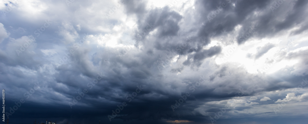 Poster the dark sky with heavy clouds converging and a violent storm before the rain.bad or moody weather s