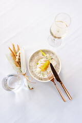 Scallop in sauce with flying fish caviar on a shell on ice in a restaurant
