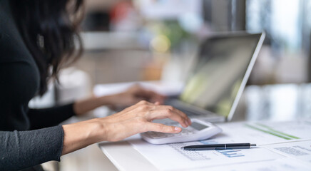 Working by using a laptop computer on wooden table. Hands typing on a keyboard.technology e-commerce concept