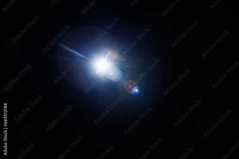 Aufkleber Easy to add lens flare effects for overlay designs or screen blending mode to make high-quality images. Abstract sun burst, digital flare, iridescent glare over black background.
