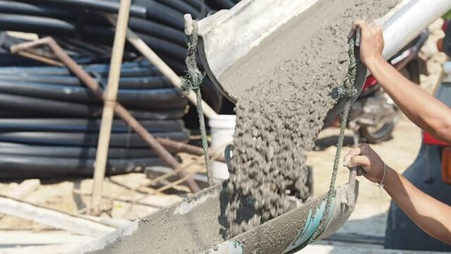 Pouring concrete on reinforced concrete roads using a ready-mix cement truck.