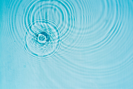 Transparent blue water surface with ripples Clear water surface texture with ripples, splashes and bubbles