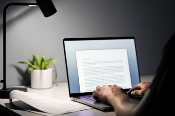 Man writing text document, essay or letter with laptop. Freelance writer, journalist or...