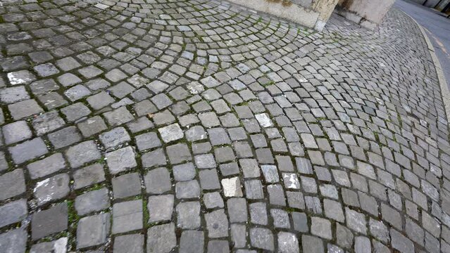 Ancient old cobblestone walkway POV of person walking in European sidewalk
