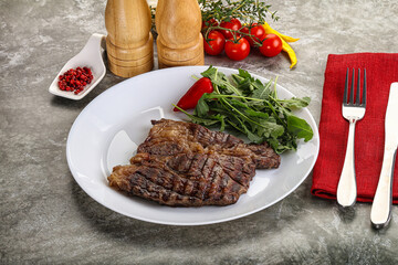 Grilled chuck roll steak with arugula