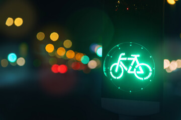 Bicycle green allowing lamp sign on traffic light road highway driveway drive crossroad intersection evening dark time german city. Bike forward movement safe on semaphore signal city street - obrazy, fototapety, plakaty