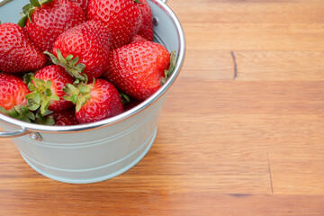 Fresh organic strawberries just picked from the garden in within a beautiful vintage pastel light blue font.