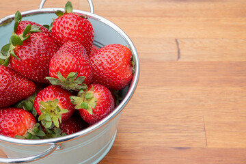 Fresh organic strawberries just picked from the garden in within a beautiful vintage pastel light blue font.