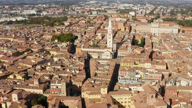 Aerial view of the Modena Cathedral and Torre della Ghirlandina, the bell tower of this Roman Catholic church. In background there is the Ducal Palace of Modena, Emilia Romagna, Italy.