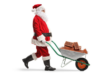 Santa claus walking and pushing bricks in a wheelbarrow