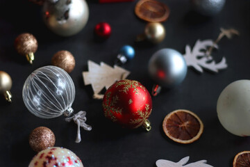 Various colorful Christmas ornaments on dark background, selective focus.
